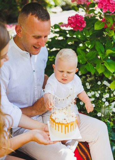 Mom and dad in nature with their one-year-old son...