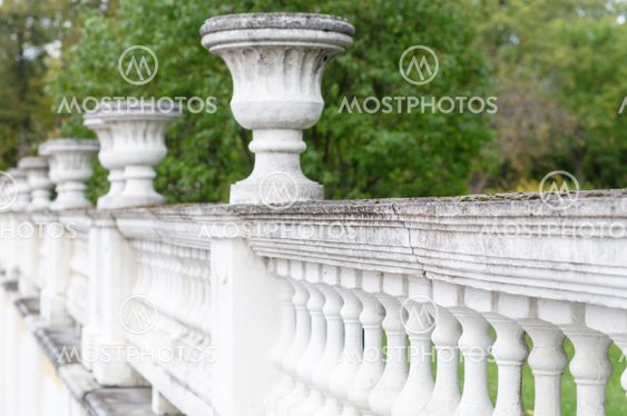 Ancient concrete fence with decorative bowls
