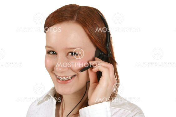 Happy young customer service representative in headset