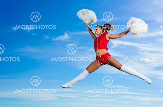 Young cheerleader in red costume jumping