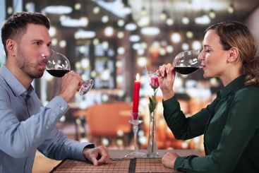 Portrait Of Romantic Couple Toasting Red Wine