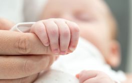 Newborn's grip symbolizes trust and safety. Concept of...