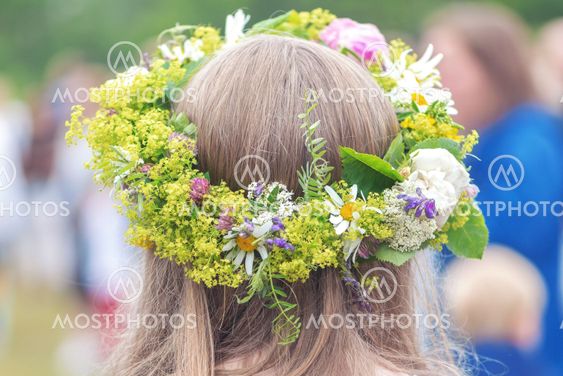 People celebrating midsummer with dance around the maypole