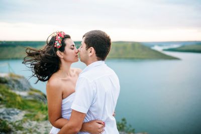Loved couple in love at amazing landscape against cliff...