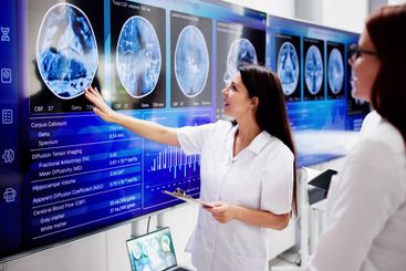 Doctors In Clinic Looking At Brain MRI Scan