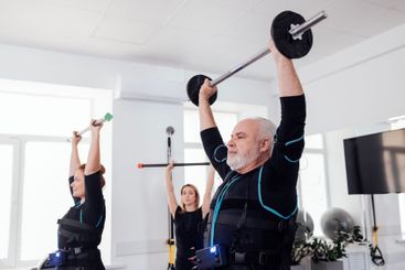 Elderly couple doing electrical muscle stimulation...