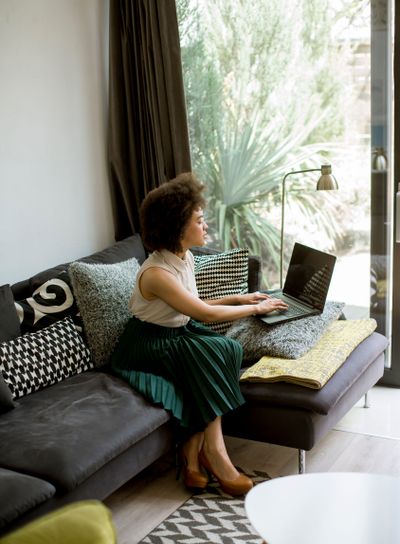 Attractive young woman working on laptop at home