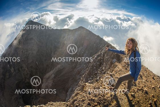 girl sits on the edge of cliff