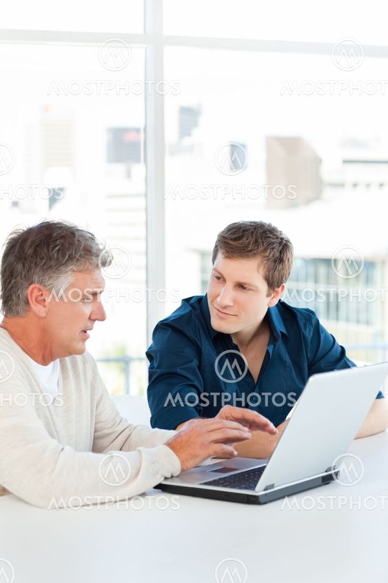 Two businessman working on their laptop