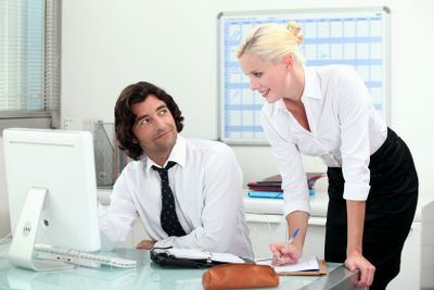 Attractive couple working in an office
