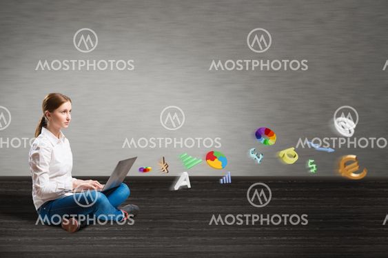 young girl sitting on the floor with a laptop