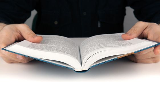 Man's hands and man looking for something in the book