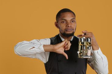 Restaurant staff giving a thumbs down sign against...