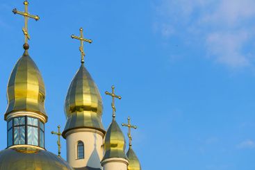 Christian cathedral with golden domes and blue clear sky