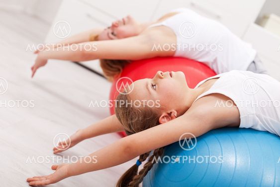 Woman and little girl exercising