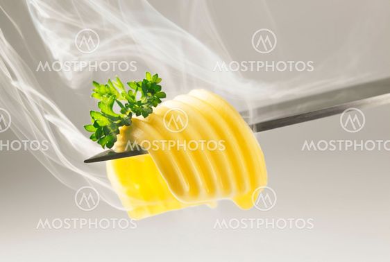 Butter curl melting on a knife