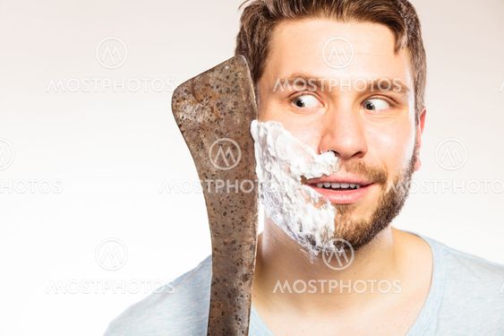 Young man shaving having fun with machete.
