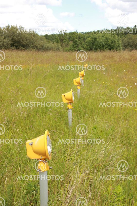 Yellow Runway landing lights in grass field