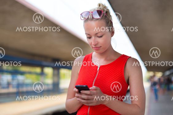 Young woman on platform of railway station.