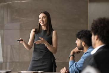 Attractive European woman coach hold seminar for staff...