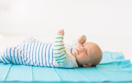 Little baby on white bed