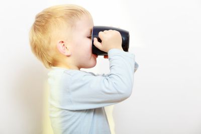 Happy childhood. Little boy kid child drinking tea