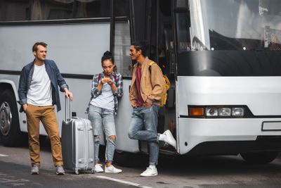 selective focus of multiethnic friends standing with...