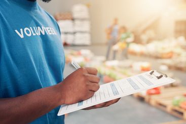 Clipboard, pen and hands of volunteer writing for...