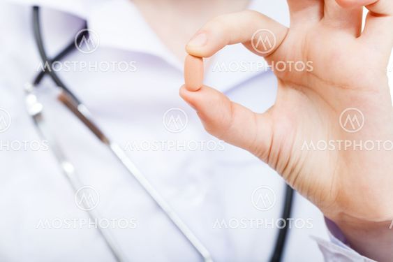 nurse holds drug in fingers