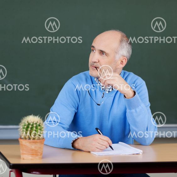 Male teacher sitting thinking