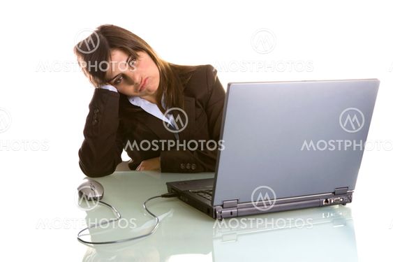 businesswoman with tired expression working with laptop computer