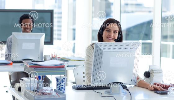 Businesswoman with a headset on working in a call center
