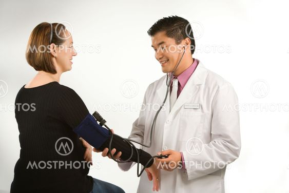 Doctor testing blood pressure.
