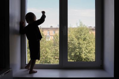 Cry for help child concept. The child looks window