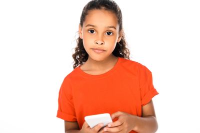 adorable african american child looking at camera while...