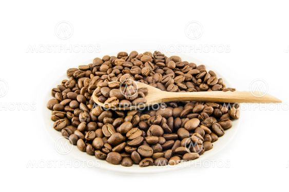Cup full of coffee beans isolated