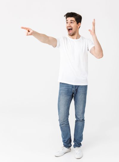 Full length portrait of a cheerful young man