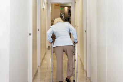 Woman With Walker In Corridor