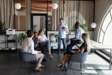 Professional young male team leader holding negotiations...