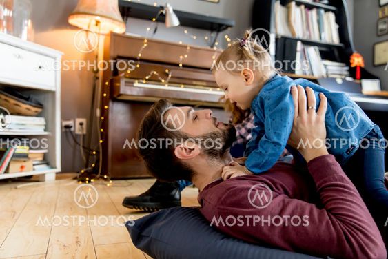 Young parents having fun with their daughter