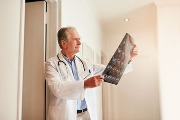 Mature, doctor and holding mri for medical or check,...