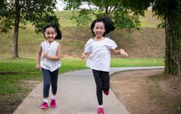 Asian Little Chinese Sisters running happily