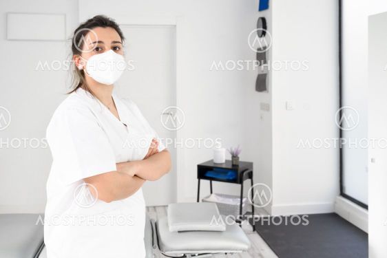 Confident female physiotherapist posing in modern clinic...