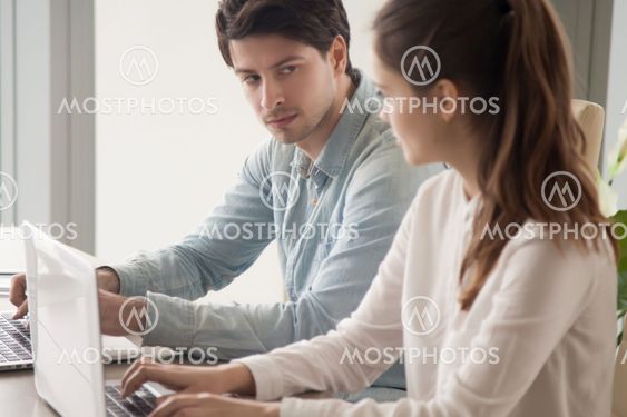 Male manager looking enviously at female rival, competition betw