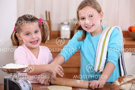 Young girls using a rolling pin