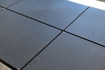 Black tiles arranged on a tabletop showcasing modern...