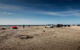 People and cars on beach