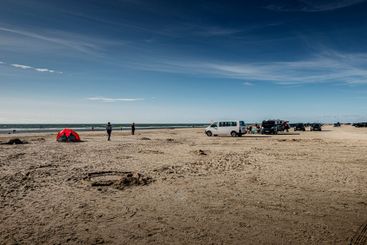 People and cars on beach