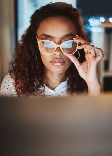 Reading, remote work and woman at night on laptop for...