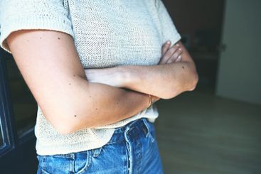 Closeup woman, person and arms crossed in home with...
